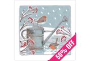 Two robins perched on a watering can surrounded by snowy winter branches with red berries. A 50% off ribbon crosses a corner