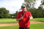 Ricky Groves standing on the golf looking at the camera with a hole flag in the background