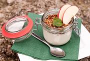  Gemini said A glass jar filled with yogurt, granola, and apple slices sits on a green napkin with a spoon. Perfect fuel for a charity cycle!