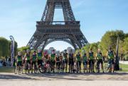 Happy riders line up in front of the Eiffel Tower
