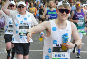 Smiling runners in Action vests