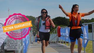 two women run towards finish line