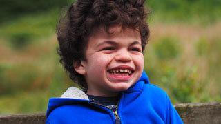 Smiling Danny who was diagnosed with Hunter Syndrome at 3 years old