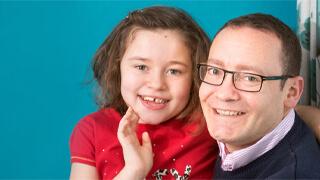 Young girl Lily with her dad on a blue background