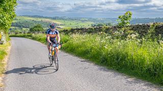 cyclist riding up yorkshire hill climb