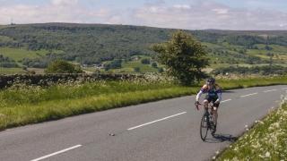 cyclist riding through the yorkshire dales