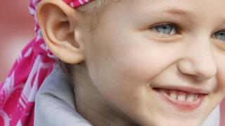 Banner showing a young girl wearing a banner around her head covering her hair