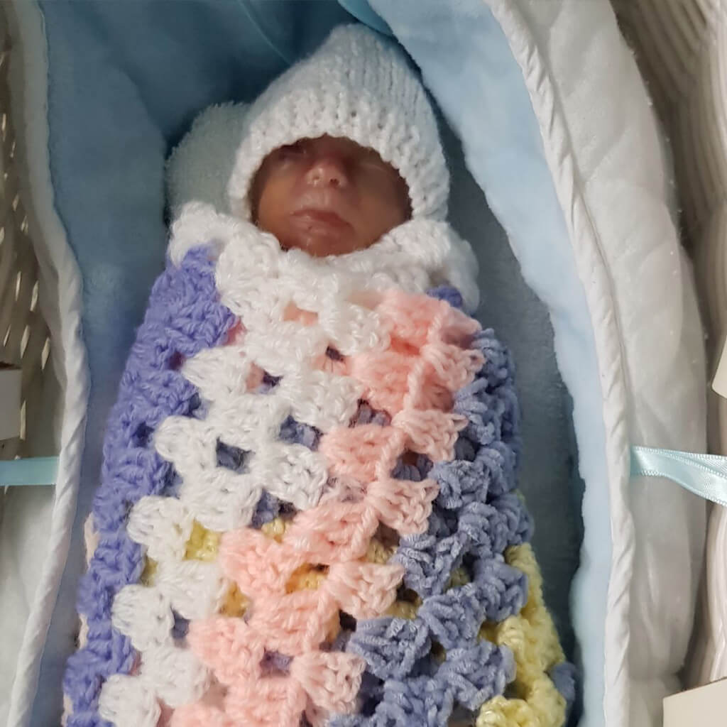 Ben, who was born 21 weeks early wrapped in blanket